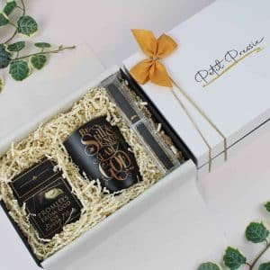 A beautifully arranged faith gift box containing a scripture mug, promise cards, and a sleek pen, ideal for gifting.