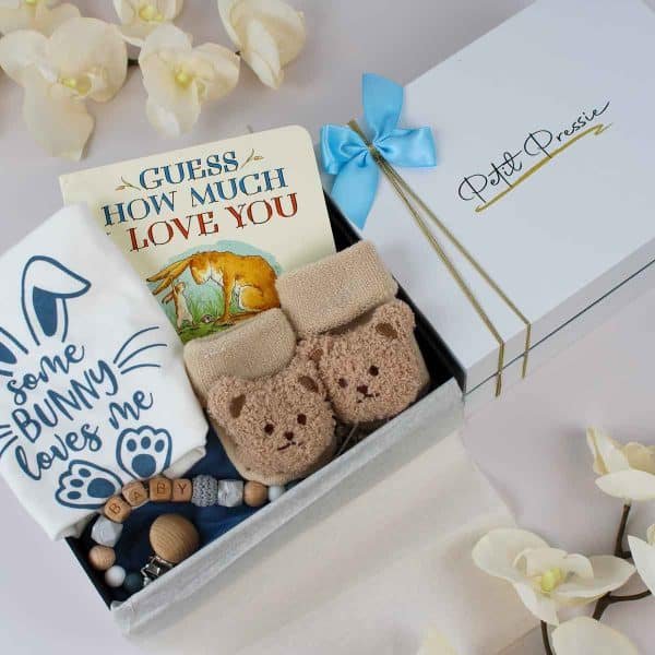 Baby boy gift box with "Guess How Much I Love You" book, bunny-themed bodysuit, and teddy bear socks