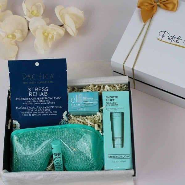 Close-up of a get well soon gift box featuring a stress relief facial mask, collagen eye cream, hydrating face cream, coconut lip balm, and a cooling gel eye mask, perfect for gifting.