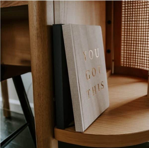 You Got This Gift Box - Motivational Essentials Set 10 Motivational notebook with “YOU GOT THIS” embossed in gold on a wooden shelf