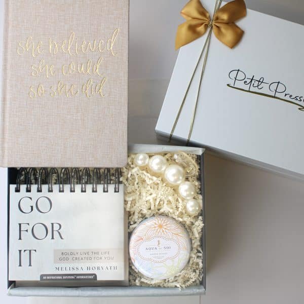 Christian-themed gift box with motivational journal, inspirational flip calendar, candle, and pearl bracelet
