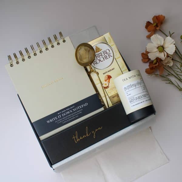 Hands holding luxury thank you gift box with premium contents and gold details
