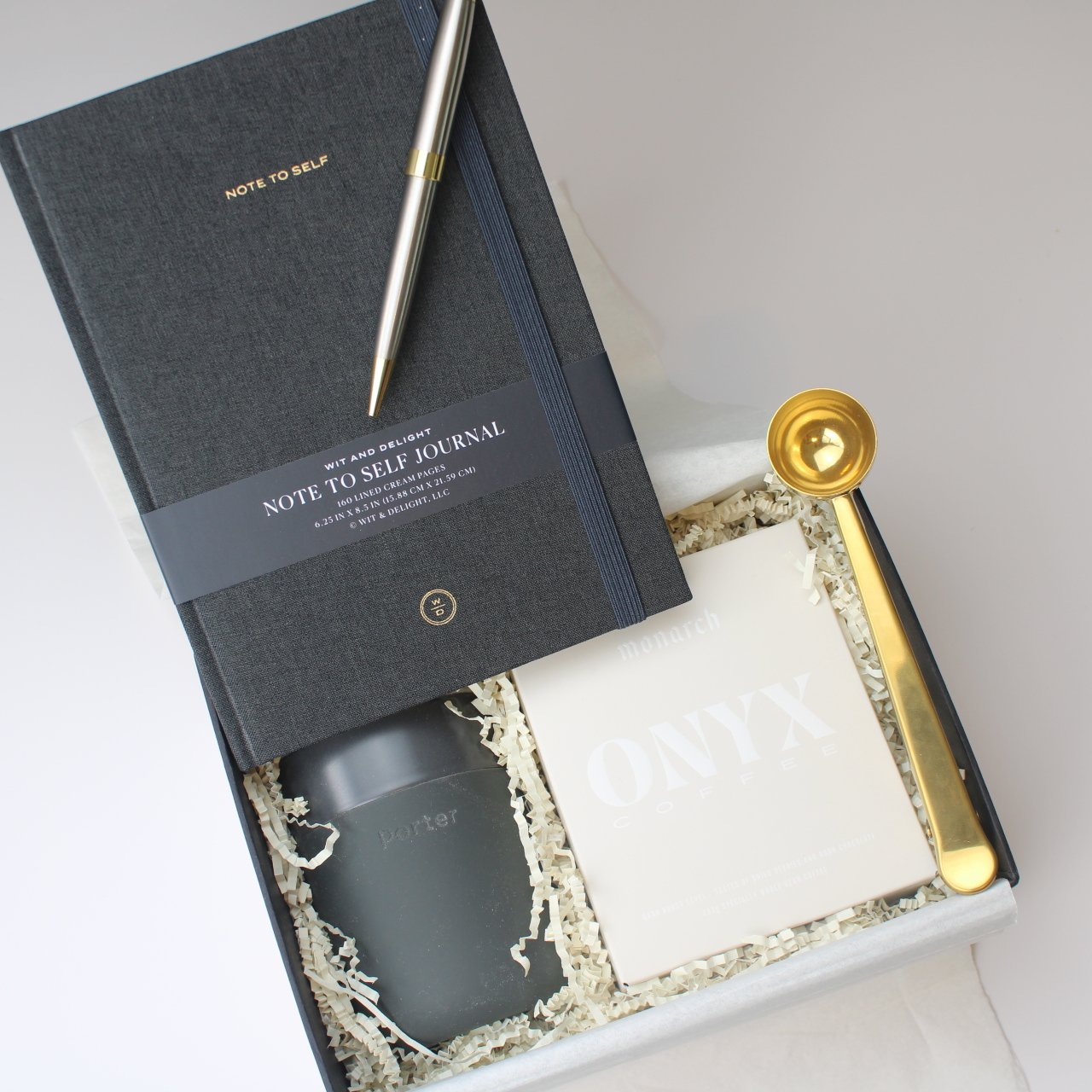 “Start with Intention” Gift Box – Coffee, Clarity & Purpose 1 Faith-based gift box with journal, Onyx coffee, gold scoop, and reusable travel mug in white shredded fill