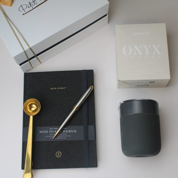 “Start with Intention” Gift Box – Coffee, Clarity & Purpose 8 Flat lay of Christian gift box components — journal, Onyx coffee, ceramic mug, pen, and gold scoop, with Petit Pressie box in background