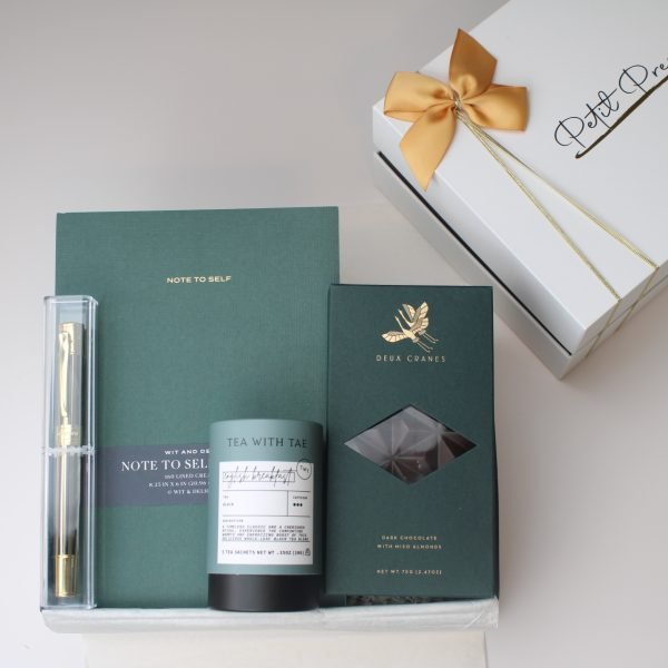 Self-care gift box for her with English breakfast tea, forest green journal, gold pen, and Deux Cranes chocolate – gift set by Petit Pressie